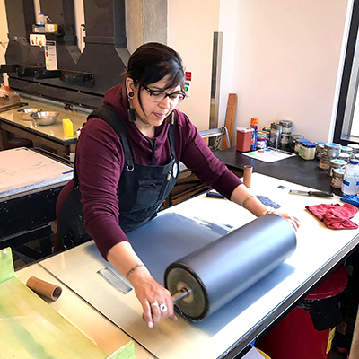 Anna Escobedo working at the printmaking shop