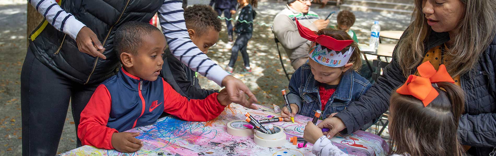 Children create art at a table.