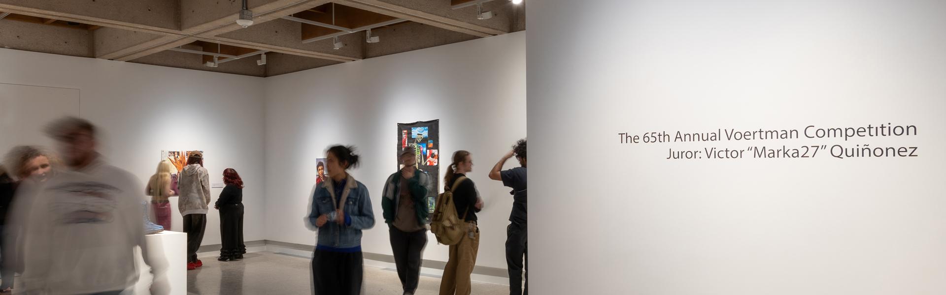 65th Annual Paul Voertman Juried Student Competition and Exhibition. People viewing the exhibition.