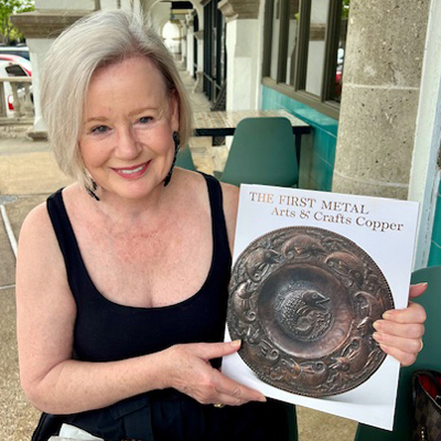 Marilyn Archer holding up her new book.