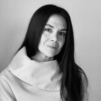 Adelia is facing forward and smiling in this black-and-white photo.