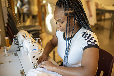 Fashion design student at the sewing machine