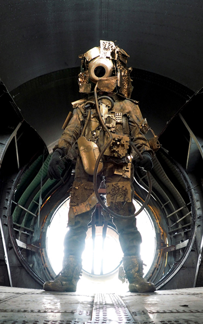 Model wearing a gold-colored metal astronaut suit.