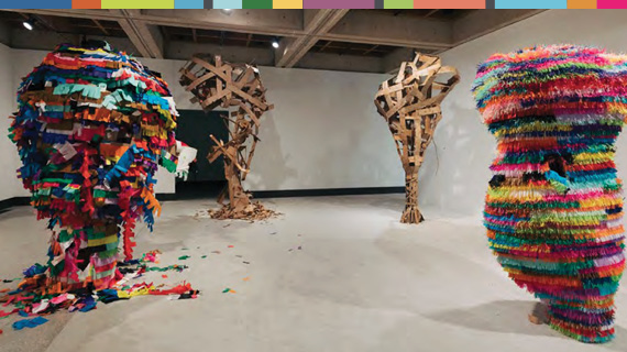 Large sculptures covered in colorful crepe paper.