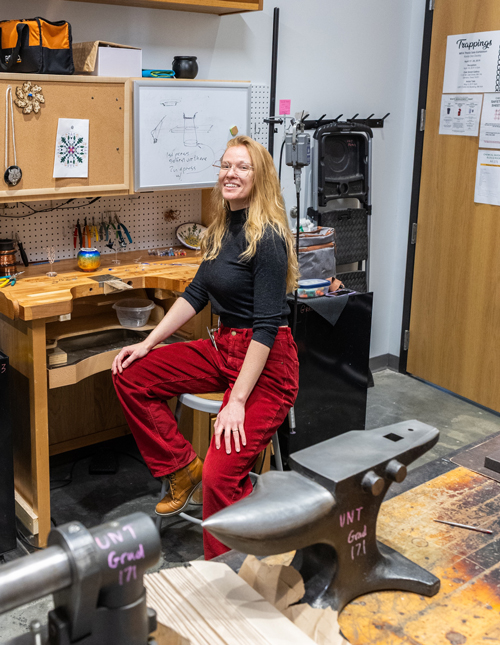 Marina Earley sits in her art studio for metalsmithing and jewelry.