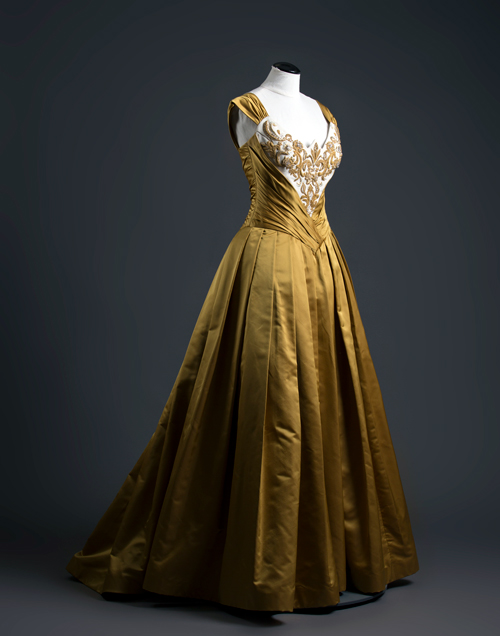 Floor-length gold ballgown on a mannequin.