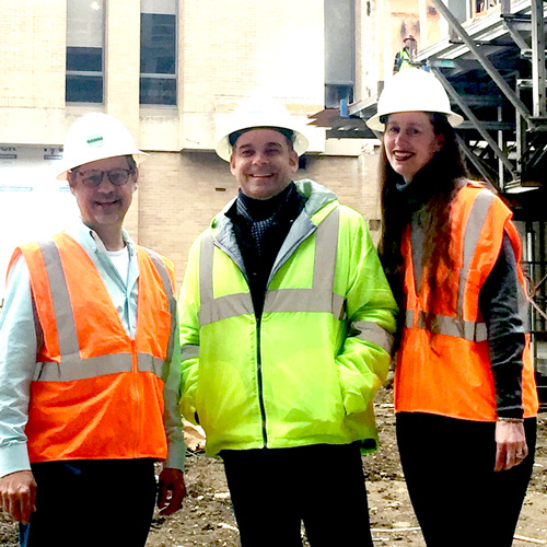 Eric Ligon, Former Dean Greg Watts, and Denise Amy Baxter wearing construction hats and vests.