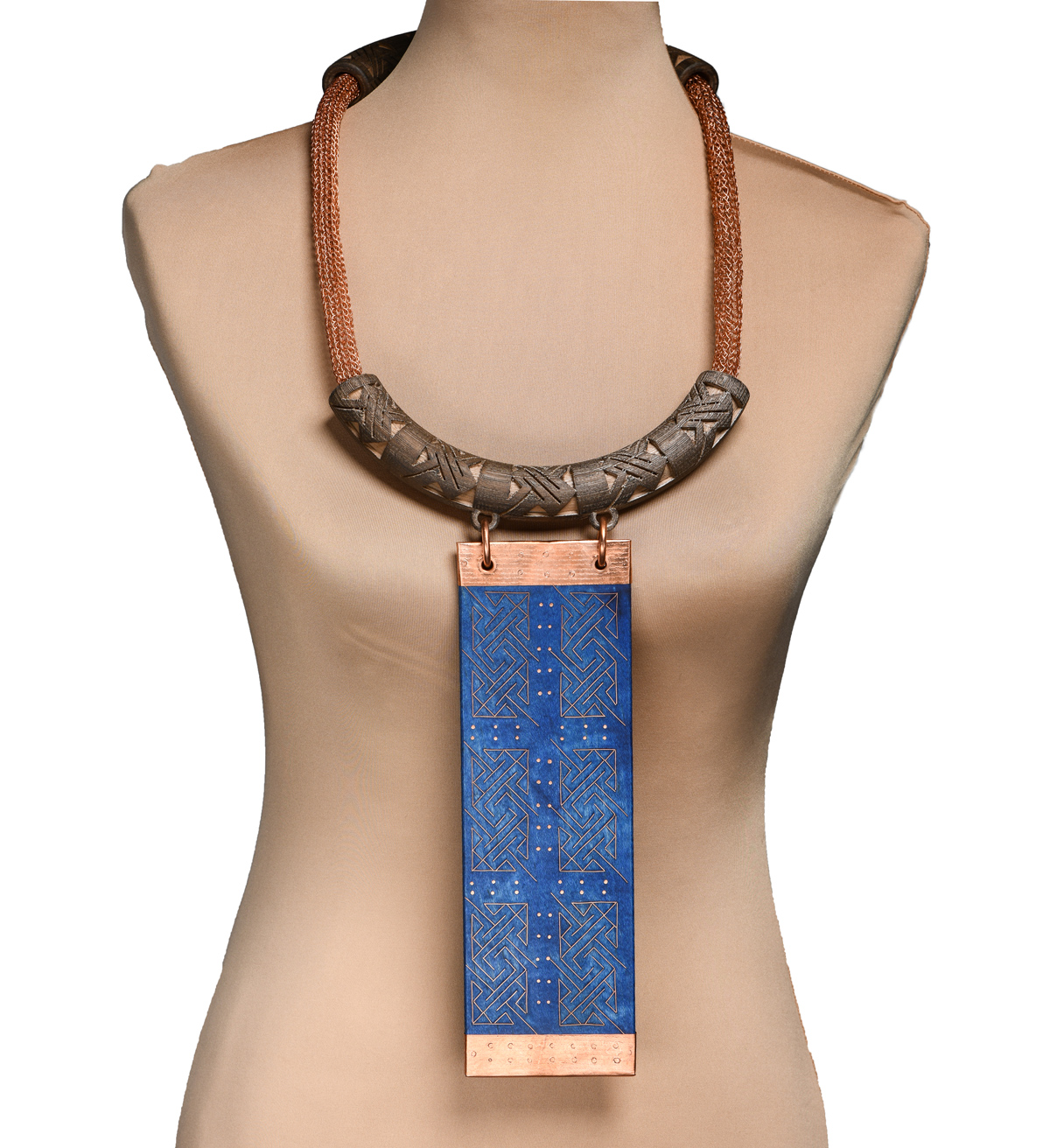 Necklace made with two 3D printed brown wood PLA tubes with etched carvings etched, knitted wire connects two tubes. A blue rectangle wooden pendant is attached to the necklace.