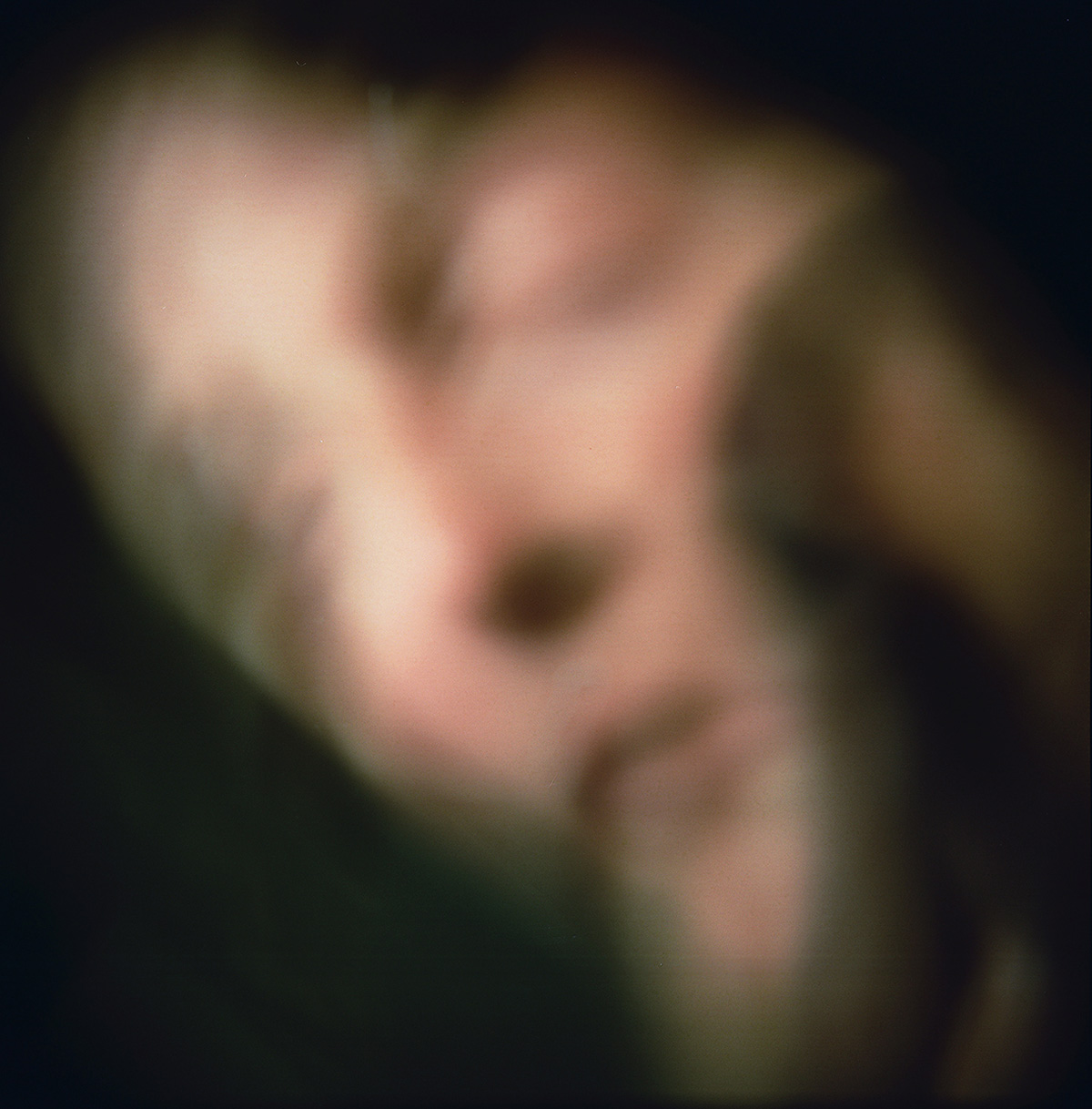 Color photographic image of a face that is blurry. 