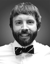 Jeremy Bernardoni facing forward, smiling, beard and mustache, wearing a bow tie