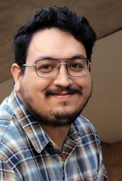 Kevin Contreras, black-and-white photo, wearing glasses, short beard