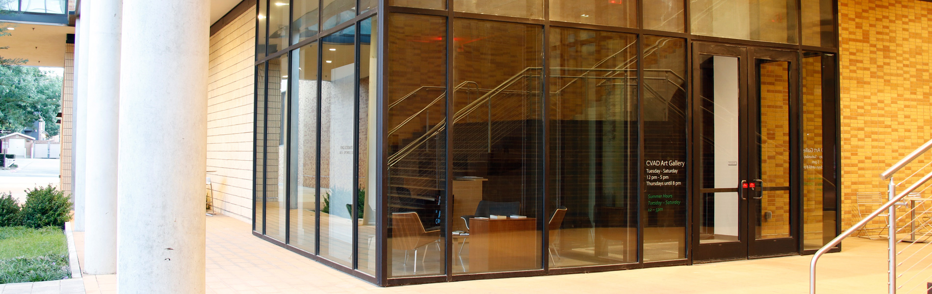 CVAD Gallery glass entry doors with the brick staircase in the reflection.