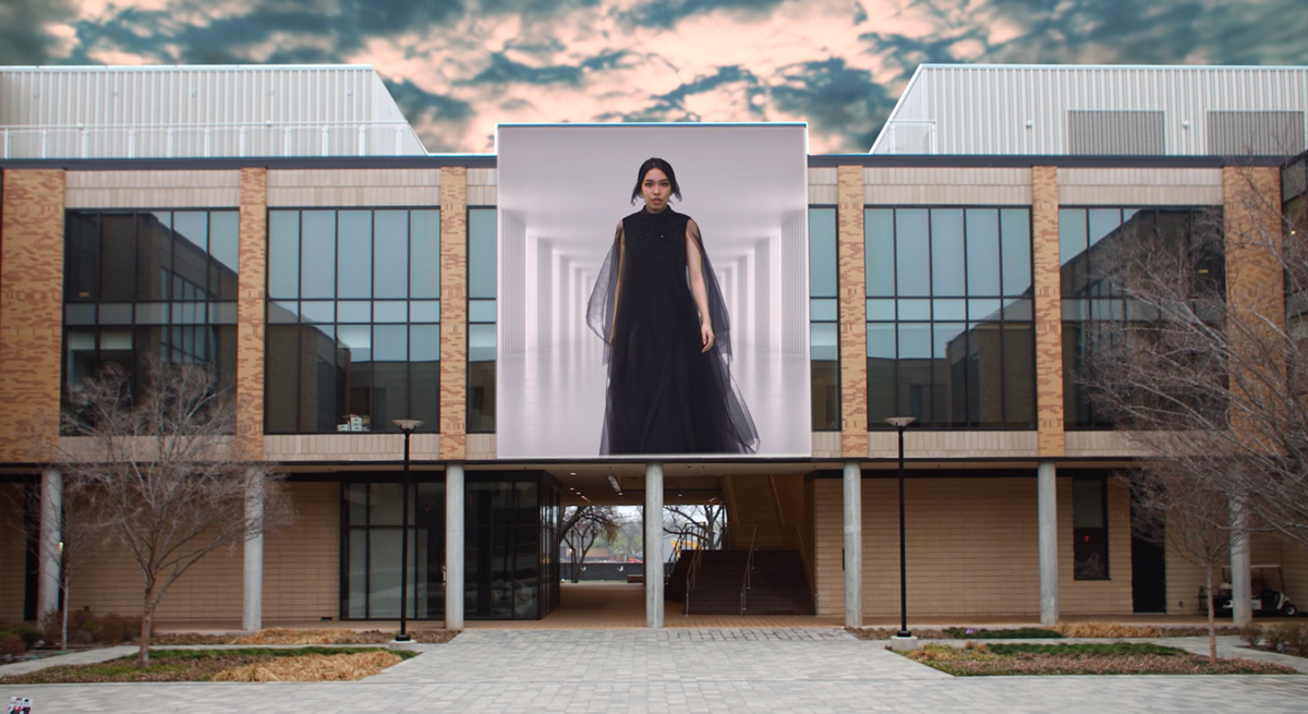 Fashion Design Senior Show image; model projected onto the Art Building facade