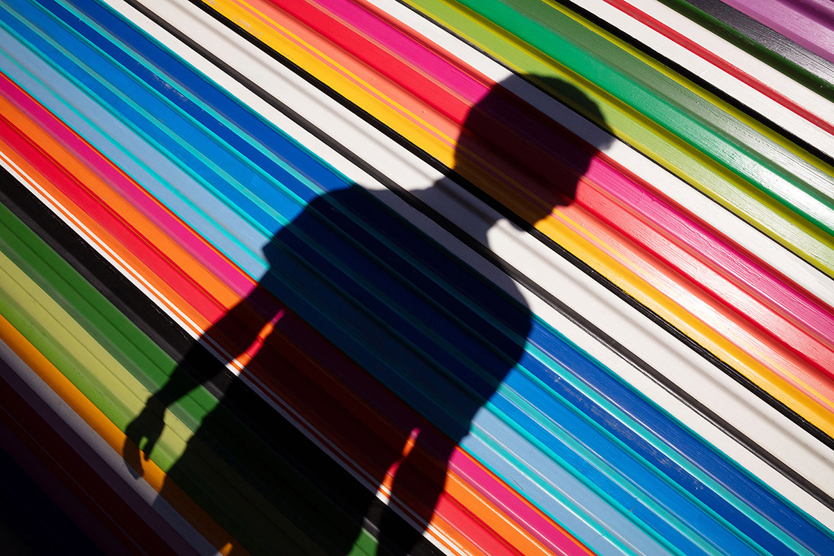 Brightly colored stripes with the silhouette of a man in black