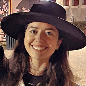 alyssa wearing a black hat, looking forward and smiling