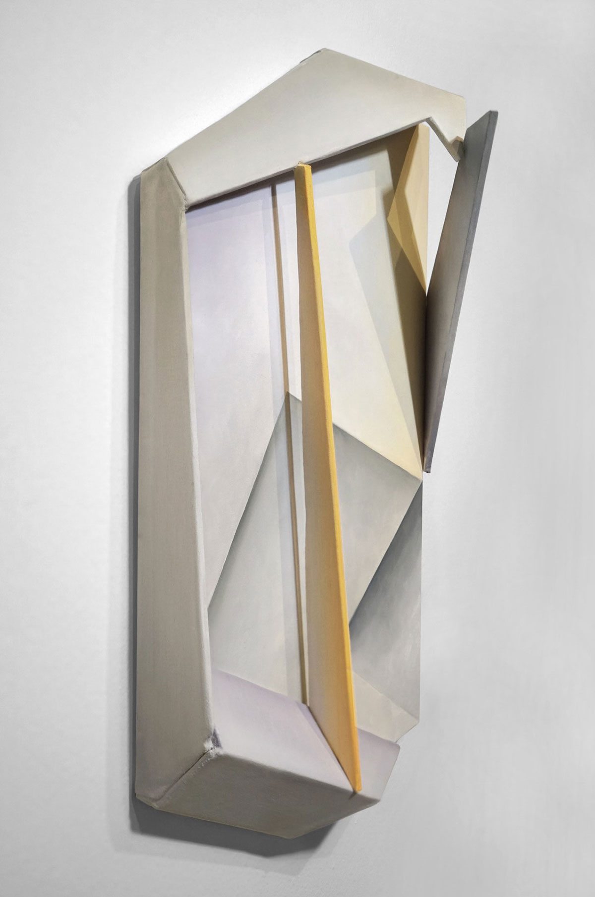 A 3D sculptural artwork with white, gray, and yellow intersecting geometric shapes.