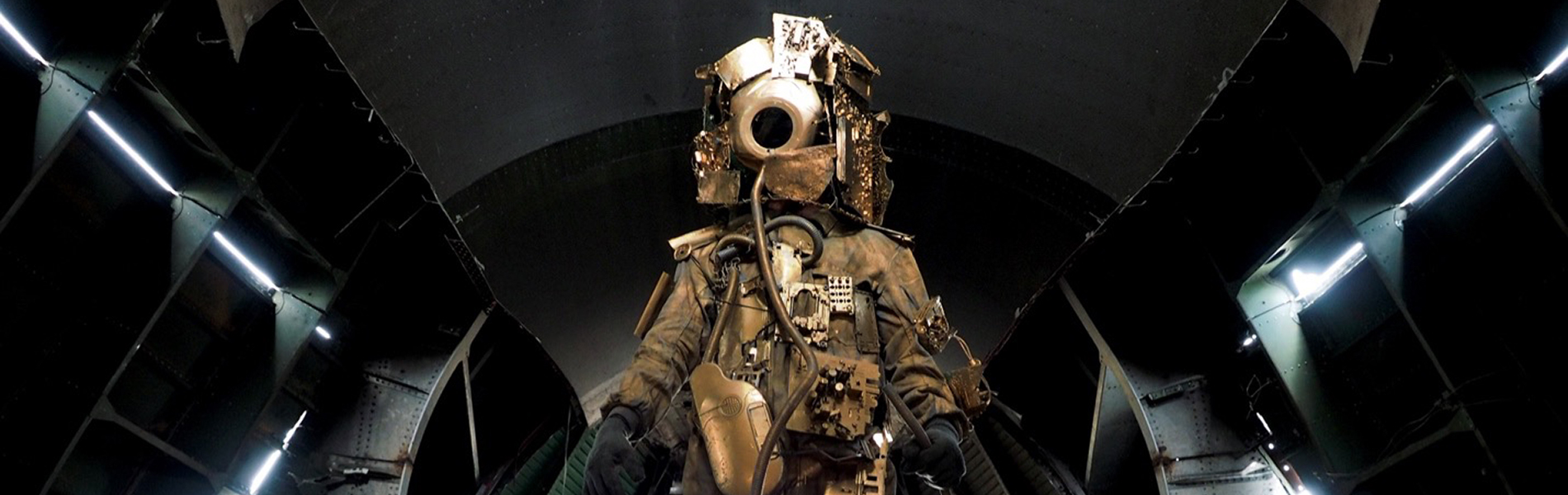 A spacewalker in a golden suit plastered with electronic circuits and other digital debris