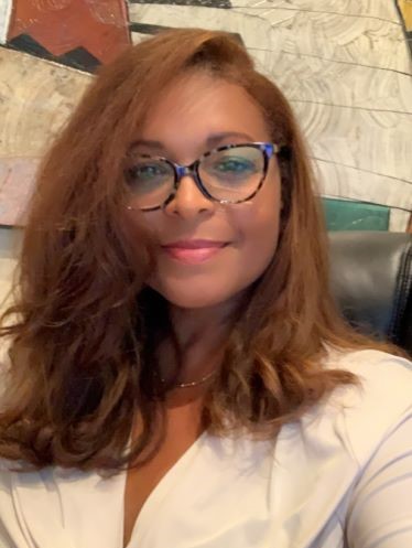 Felicia Lewis smiling, long auburn hair, glasses