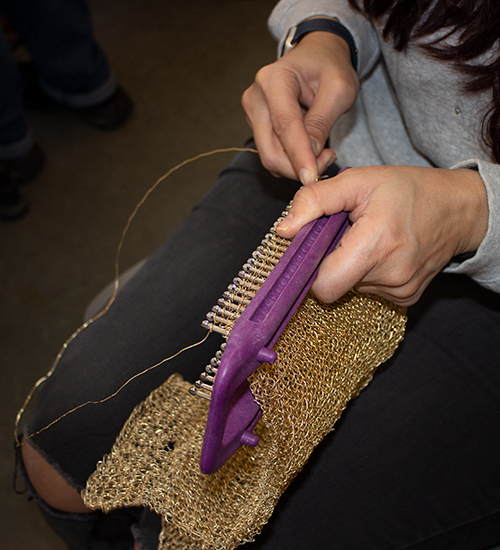 Student weaving with metal wire