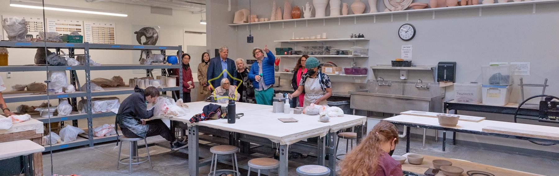 A group of visitors to the Throwing Room in the Art Annex