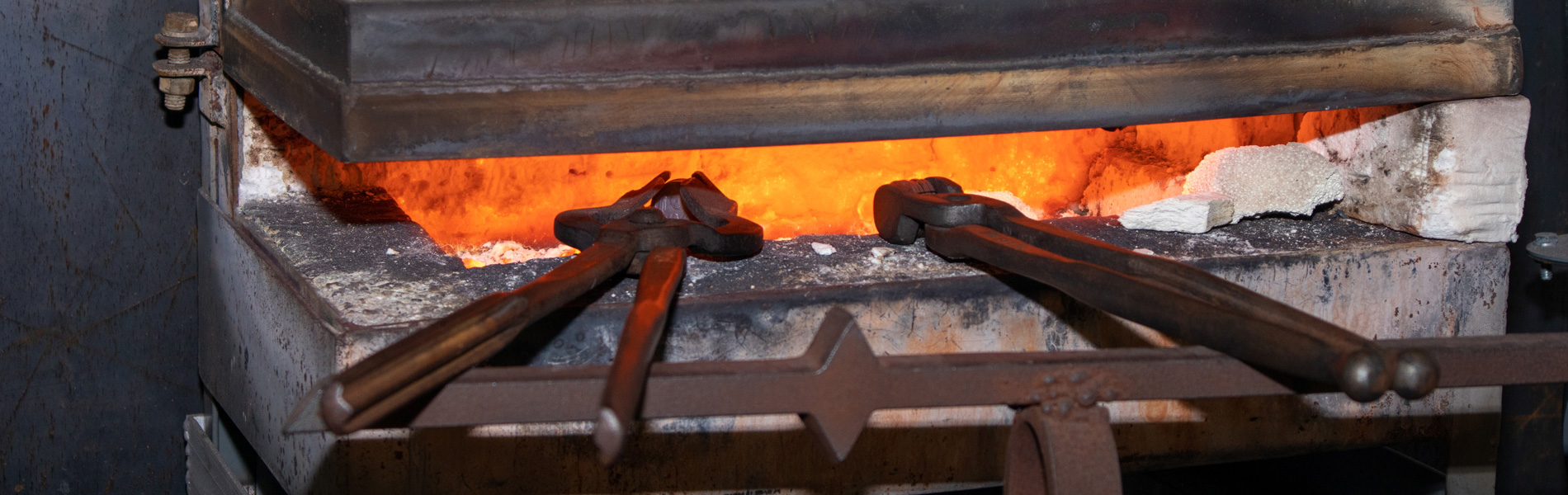 Metalsmithing tools heating up in a fire,