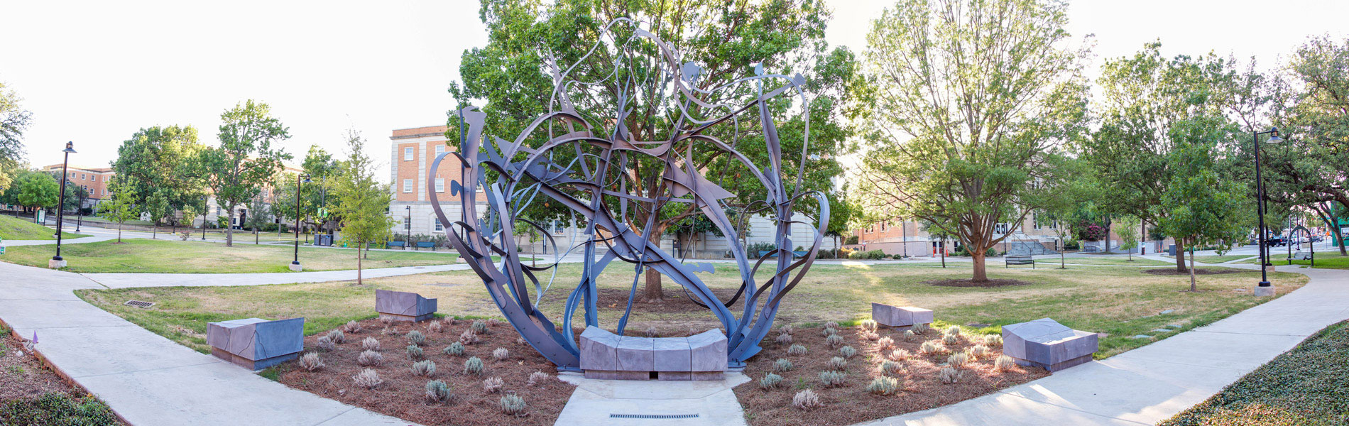 Wide outdoor view of the Art Building's west lawn with the 20' tall abstract sculpture in the center