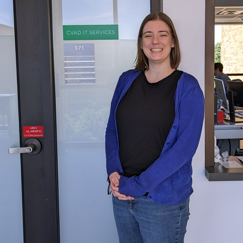 Kendra Wiese looking forward in front of the IT Services Window in the Art Building