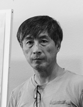 Zhang facing forward, black and white image, dark hair, light shirt
